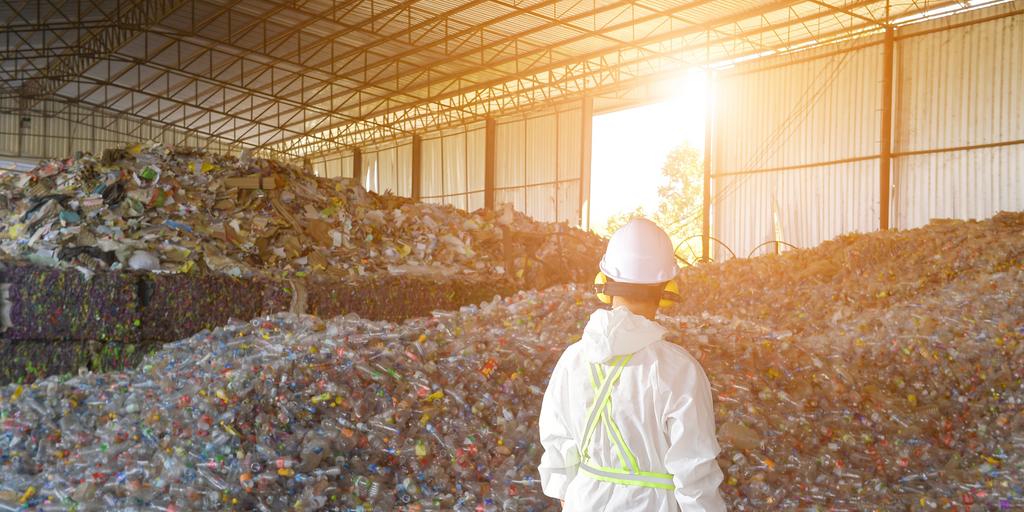 Worker in hardhat at plastic reycling center